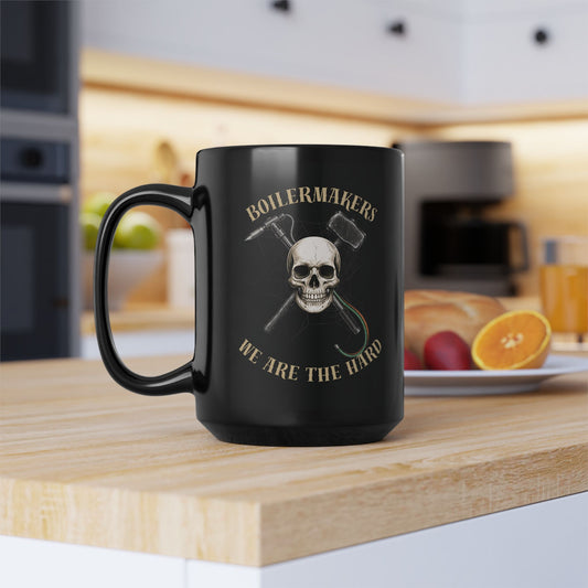 Boilermakers “We Are the Hard” Skull Mug — black ceramic, bold gold print, built for those who wake up ready to burn hotter and work harder.